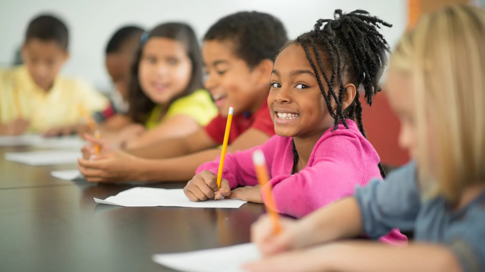 Students taking notes during a live class